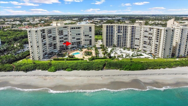 aerial view with a water view and a beach view