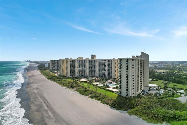 drone / aerial view featuring a water view and a view of the beach