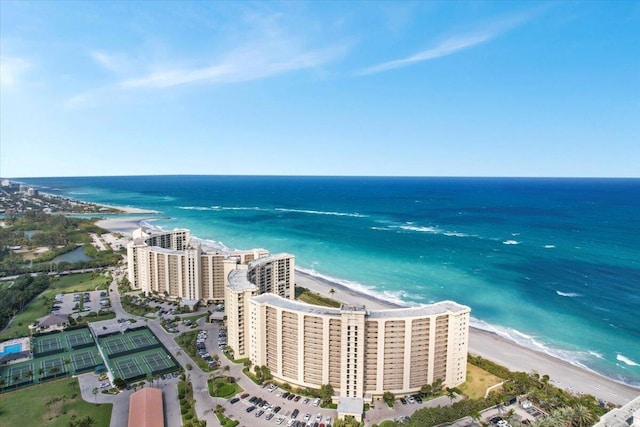 bird's eye view with a water view and a beach view