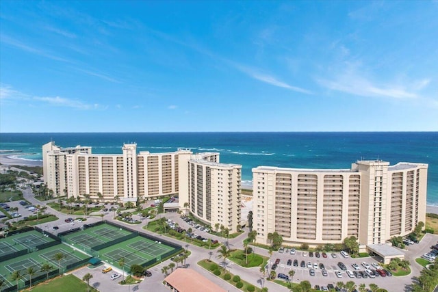 bird's eye view featuring a water view and a beach view