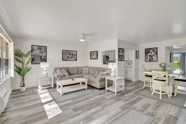 living room with ceiling fan and light hardwood / wood-style floors