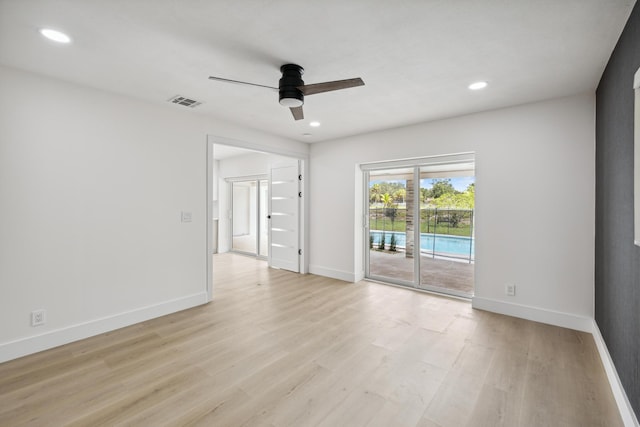 unfurnished room featuring baseboards, light wood-type flooring, and ceiling fan