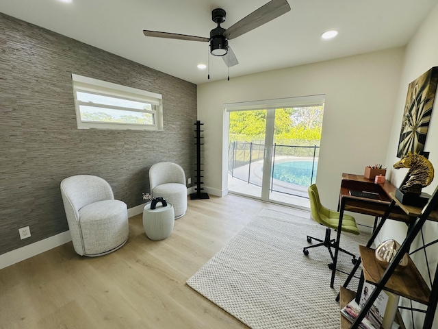 office area featuring wood finished floors, baseboards, recessed lighting, ceiling fan, and an accent wall