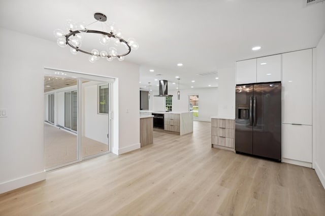 kitchen with a kitchen island, oven, modern cabinets, stainless steel fridge, and island range hood