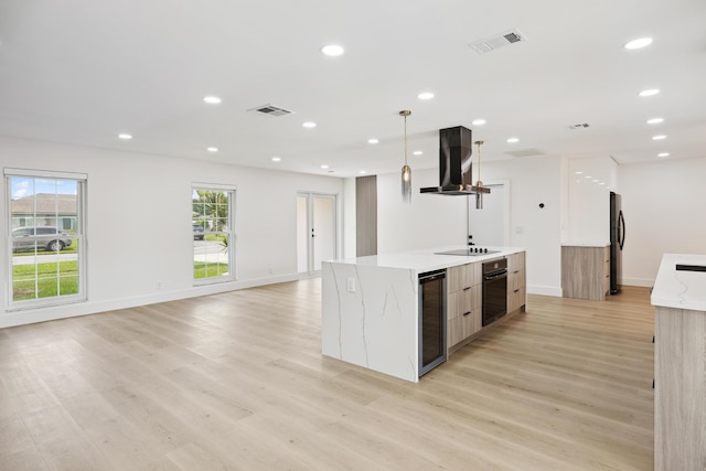 kitchen with visible vents, black appliances, wine cooler, modern cabinets, and island range hood