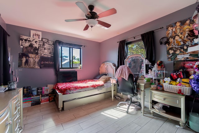 bedroom featuring wood tiled floor and a ceiling fan