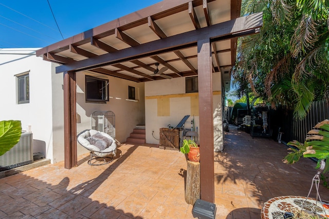 view of patio featuring fence, cooling unit, and a ceiling fan