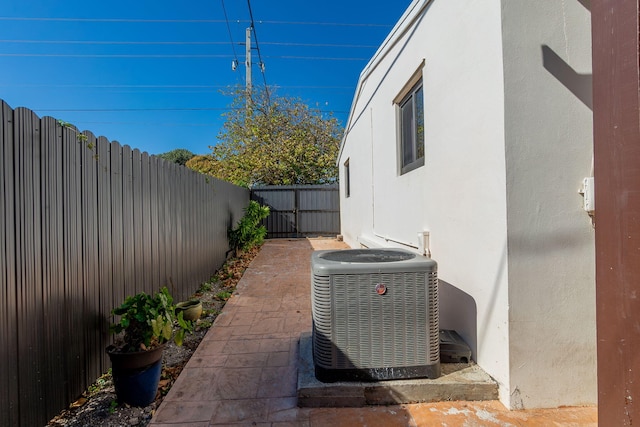 exterior space featuring a fenced backyard and central air condition unit