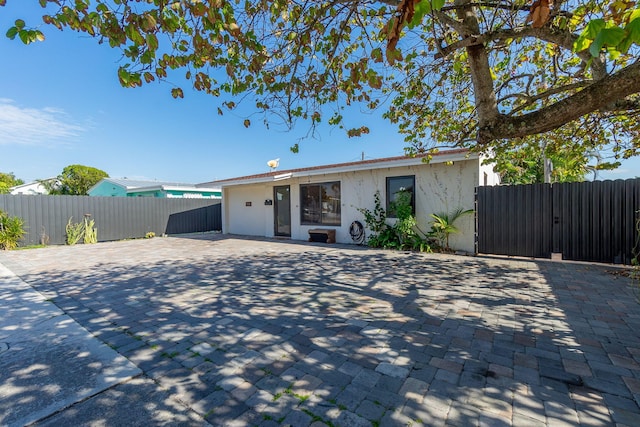 view of front of house with fence and stucco siding