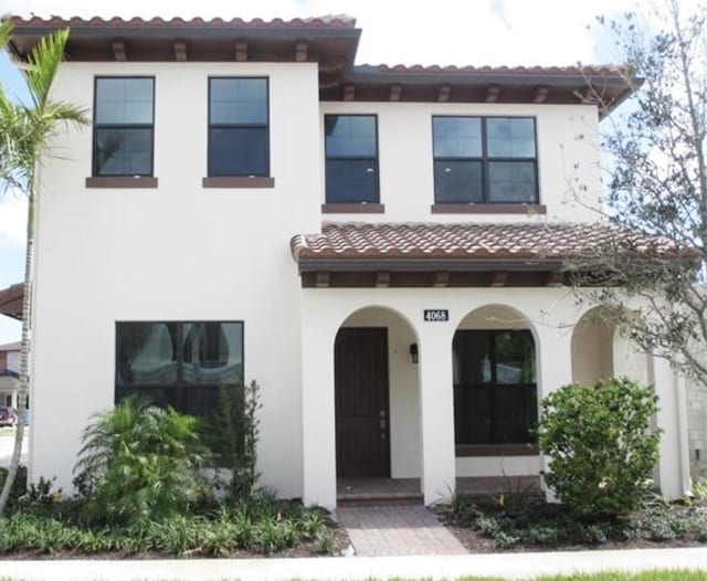 mediterranean / spanish house with covered porch