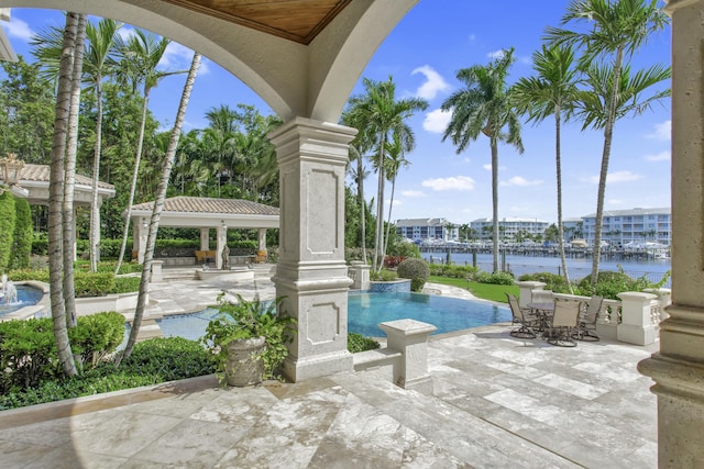 view of swimming pool featuring a gazebo, a water view, and a patio area