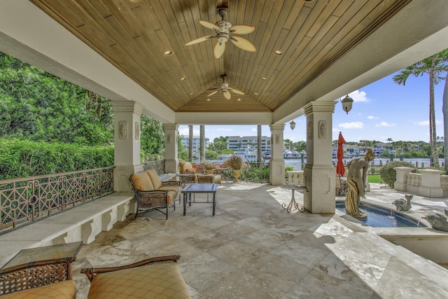 view of patio featuring a gazebo, ceiling fan, a water view, and a swimming pool