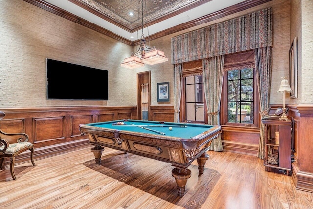 rec room with light hardwood / wood-style floors, ornamental molding, billiards, and a tray ceiling