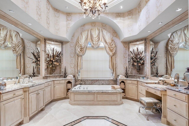 bathroom with vanity, a bath, a high ceiling, ornamental molding, and a notable chandelier