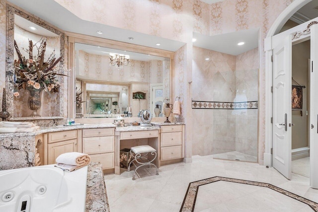 bathroom featuring vanity, an inviting chandelier, and separate shower and tub