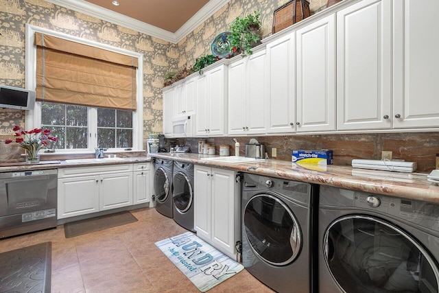 clothes washing area featuring sink, light tile patterned floors, ornamental molding, and independent washer and dryer