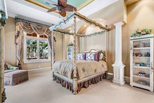 carpeted bedroom featuring decorative columns, ceiling fan, and ornamental molding