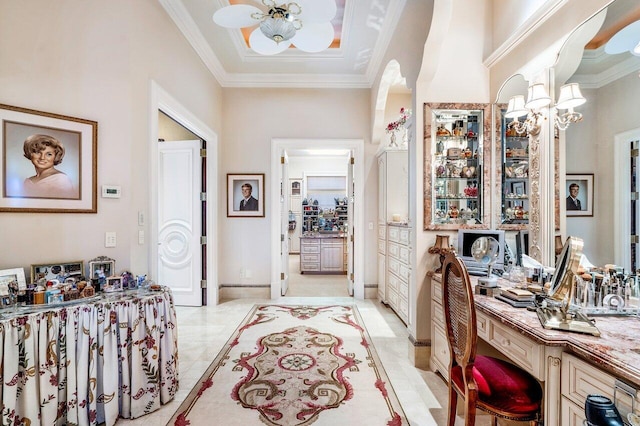 interior space with crown molding and a towering ceiling