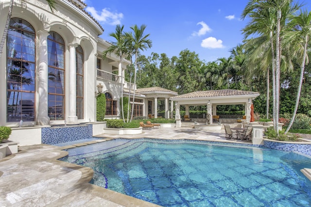 view of swimming pool with a gazebo and a patio area