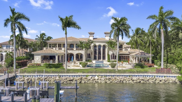 back of house featuring a balcony and a water view