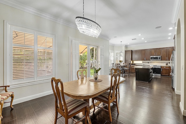 dining room featuring a chandelier, dark hardwood / wood-style floors, and ornamental molding