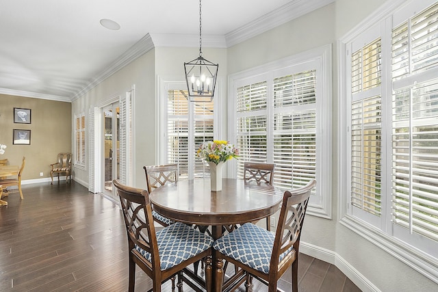 dining area with ornamental molding, dark hardwood / wood-style floors, and an inviting chandelier