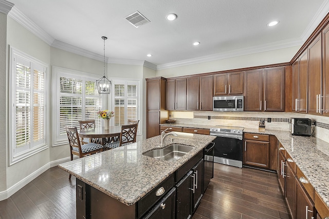 kitchen with sink, pendant lighting, a center island with sink, appliances with stainless steel finishes, and ornamental molding