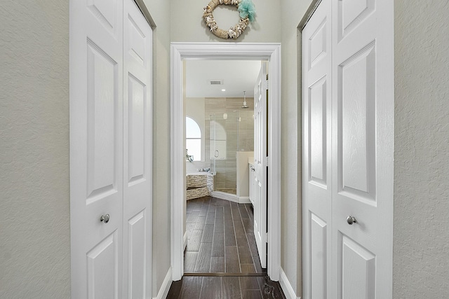 corridor featuring dark hardwood / wood-style flooring