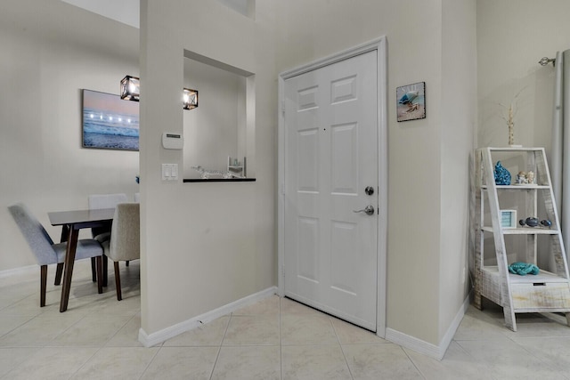 entrance foyer with baseboards and light tile patterned floors