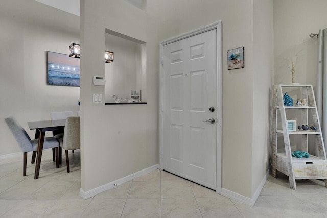 entrance foyer with light tile patterned floors and baseboards