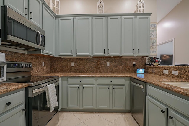 12044 Serafino St, Boynton Beach, FL 33437 - kitchen featuring stainless steel appliances, light tile patterned floors, tasteful backsplash, and stone countertops