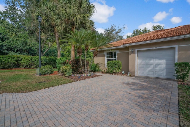 view of front of house with a garage and a front lawn