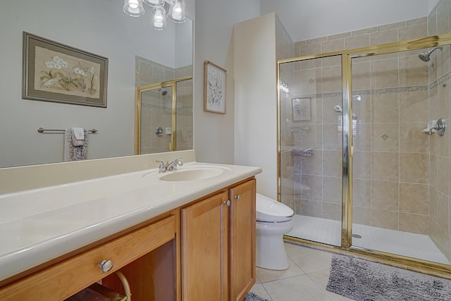 bathroom with vanity, tile patterned flooring, a shower stall, and toilet