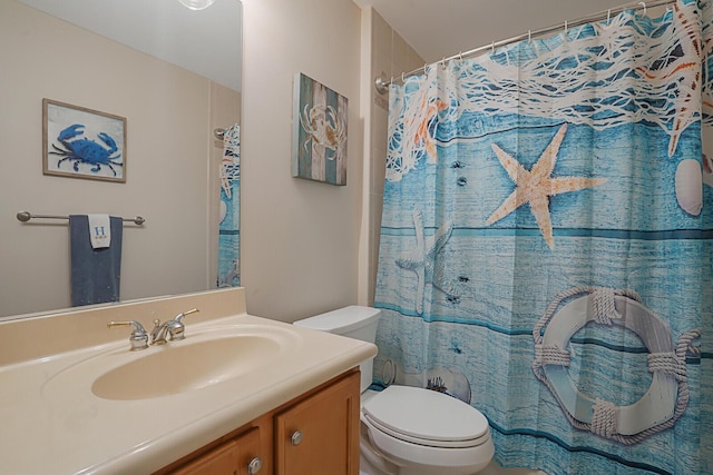 bathroom featuring toilet, curtained shower, and vanity