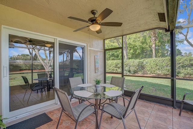 sunroom featuring ceiling fan