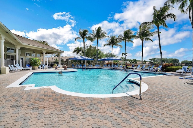 community pool featuring a patio and fence