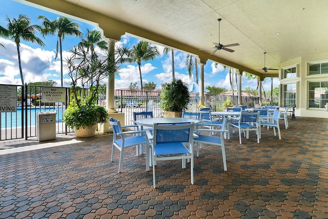 view of patio / terrace with ceiling fan, outdoor dining area, and fence