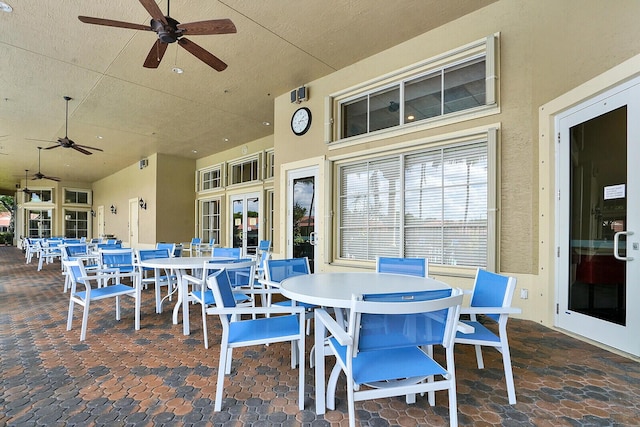 view of patio with ceiling fan, outdoor dining area, and french doors