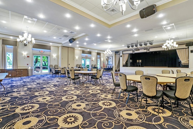 dining space featuring a chandelier, carpet flooring, and crown molding