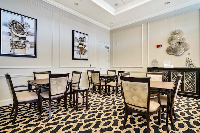 carpeted dining area featuring ornamental molding and a decorative wall