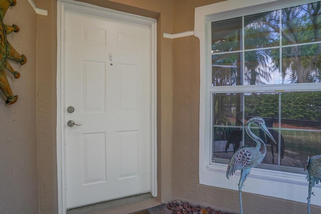 entrance to property with stucco siding