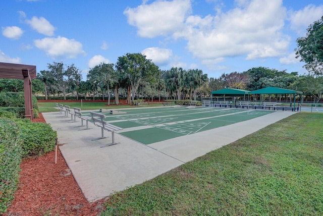 view of home's community featuring shuffleboard and a lawn