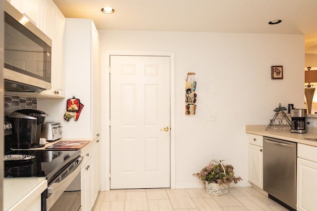 kitchen featuring white cabinetry and appliances with stainless steel finishes