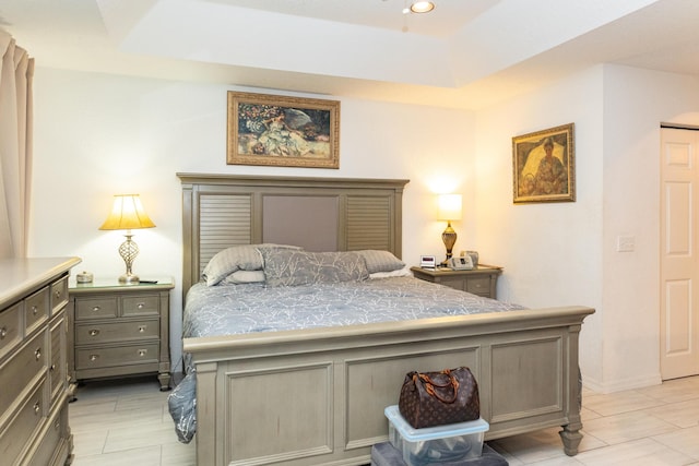 tiled bedroom featuring a raised ceiling