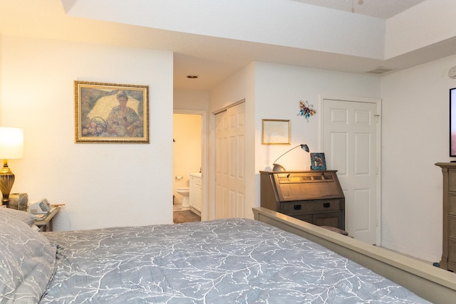 bedroom with ensuite bath and a closet