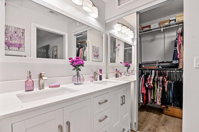 bathroom with vanity and hardwood / wood-style flooring