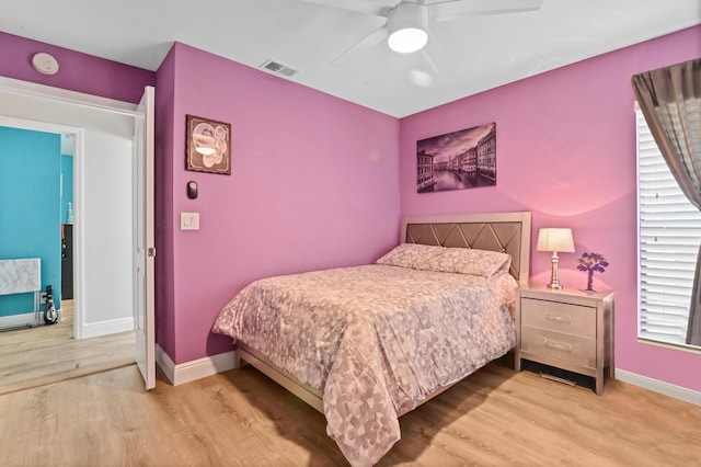 bedroom with light wood-type flooring and ceiling fan