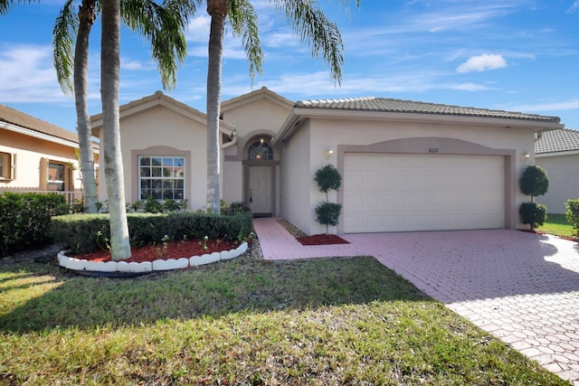 view of front of house with a garage and a front yard