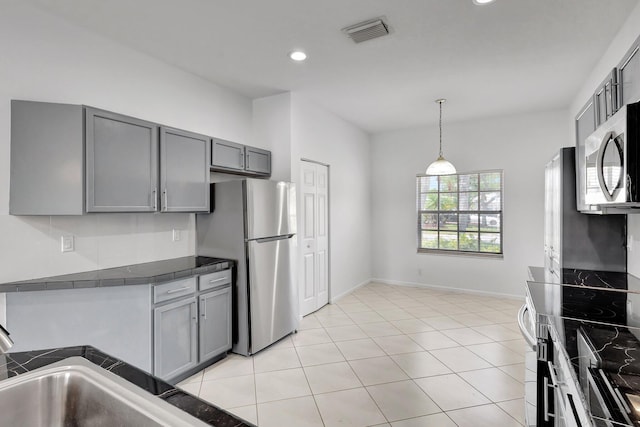 8620 Pine Cay, West Palm Beach, FL 33411 - kitchen with gray cabinets, appliances with stainless steel finishes, recessed lighting, baseboards, and pendant lighting
