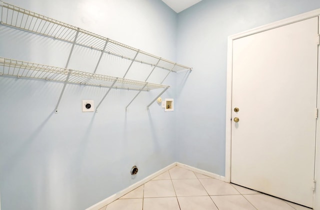 laundry room featuring hookup for a washing machine, light tile patterned floors, and electric dryer hookup